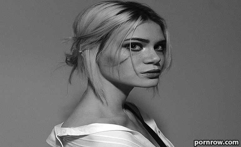 Shemale Sex Doll Buying Guide: What You Must Know First Black-and-white portrait of a woman with short blonde hair, looking over her shoulder in an open shirt.